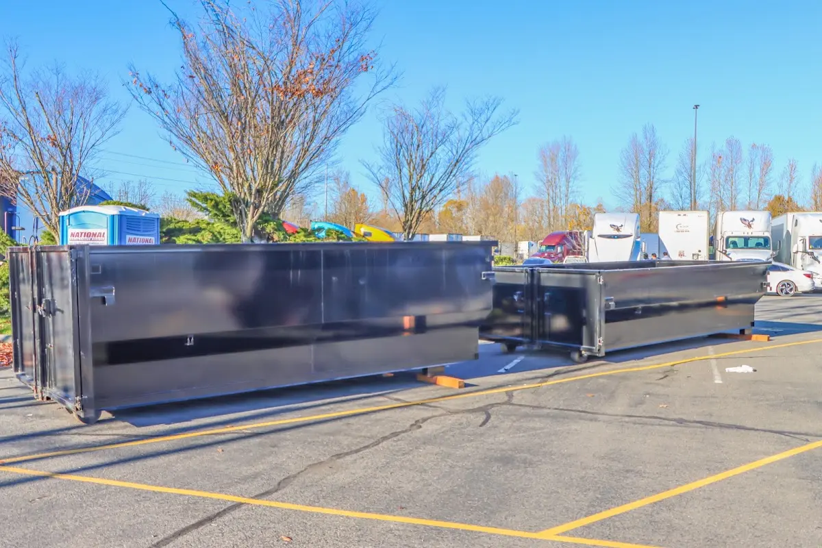 Professional dumpster rental service with roll-off container on residential driveway in Bagley